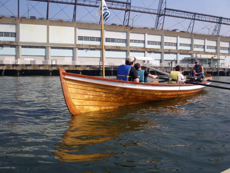 Rowers begin their journey into the Hudson River from Pier 40