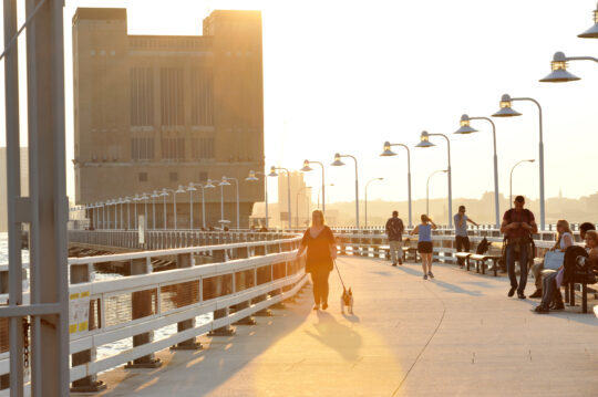 A sunny closeup of the walkway on Pier 34 where Park patrons are strolling and relaxing