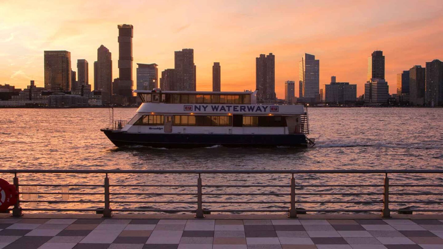 NY Waterway cruise vessel heads down the Hudson River during sunset