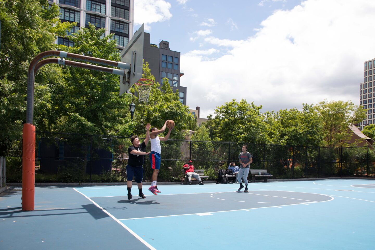 Basketball players having a game in Chelsea Waterside Park