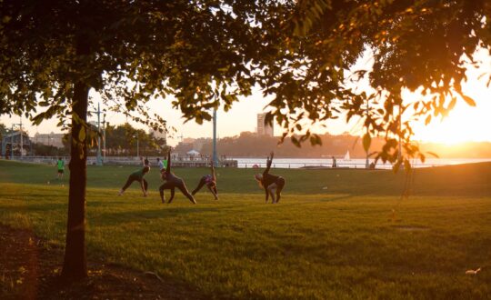 A group of visitors exercising on Pier 63 as the sun sets