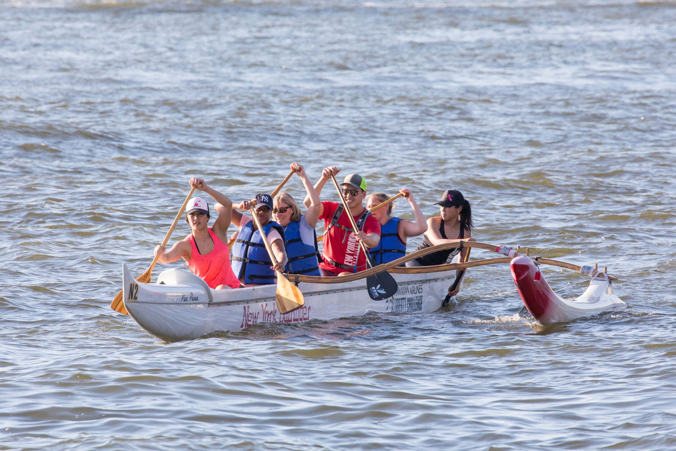 Members of Outrigger paddle their way along the Hudson River