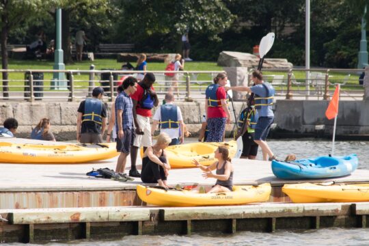 Kayakers enthusiastically prepare to launch into the Hudson River on Pier 96
