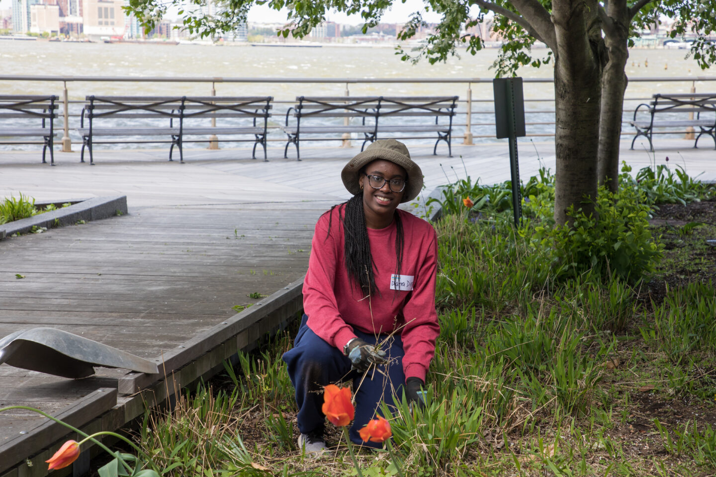 A gardener helps weed near Pier 34