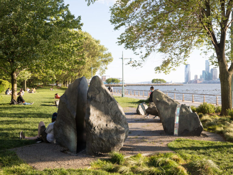People lounging near the LGBT memorial at Hudson River Park