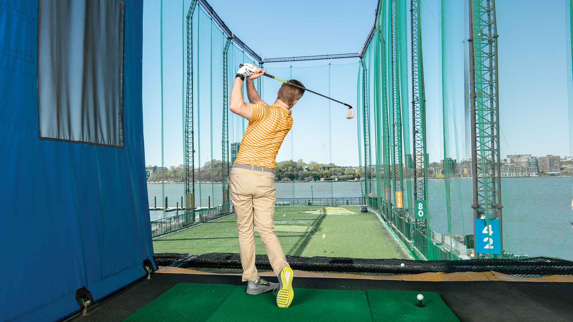 A golfer getting in some swings at Chelsea Piers