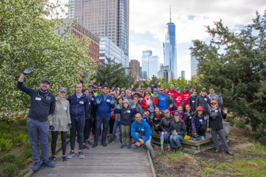 A group of volunteers standing together for a photo on the Tribeca Native Boardwalk
