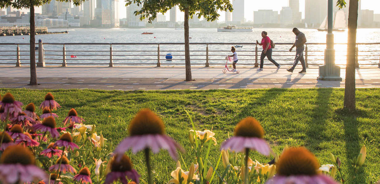 family of 3 walking at Hudson River Park