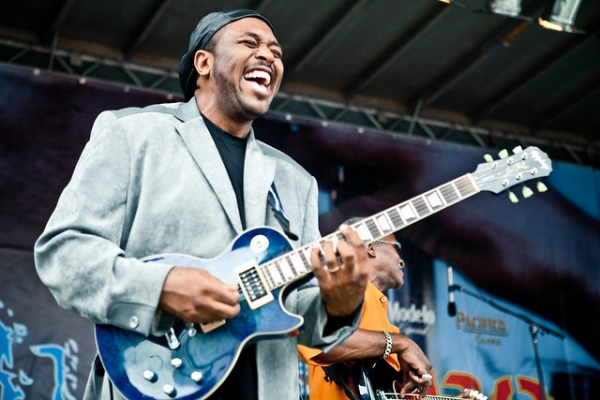 A guitarist sings and laughs during a performance at Blues BBQ in Hudson River Park