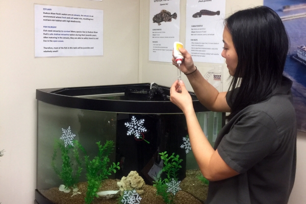 A park educator checks the PH Balance of the water in the Hudson River Park Trust's aquarium