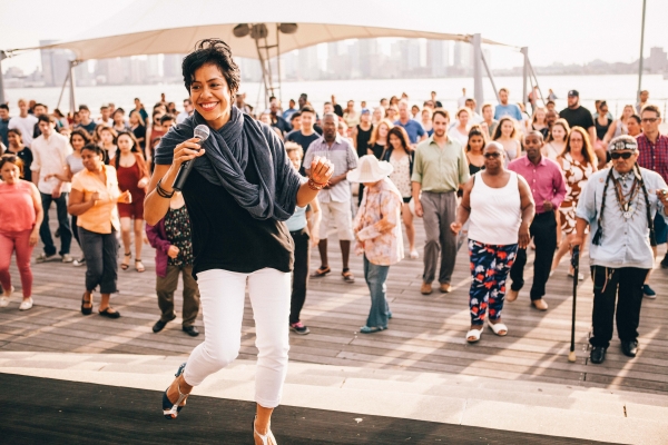 Talia Catro Pozo demonstrates how to do salsa during Summer of Fun in Hudson River Park