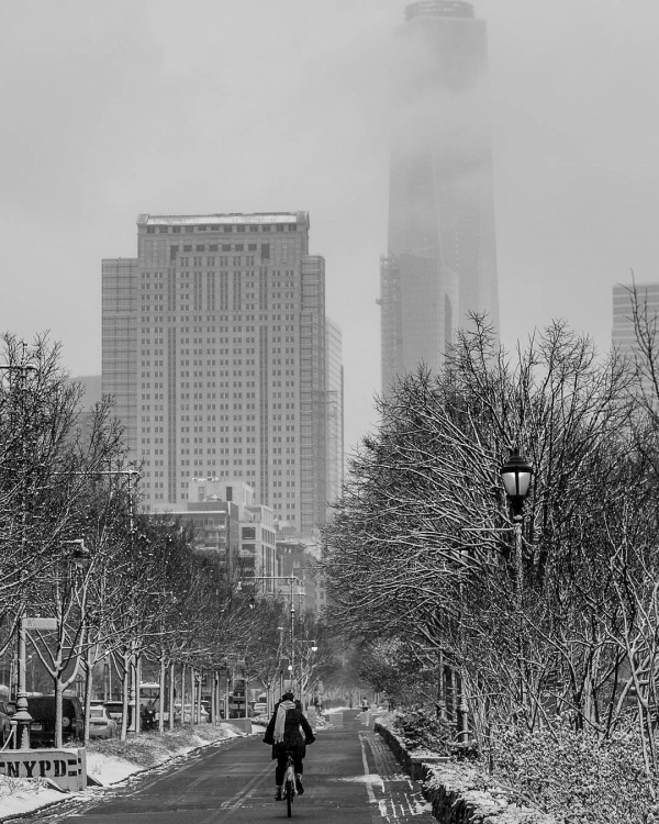 A black and white photo looking at one world trade in Hudson River Park