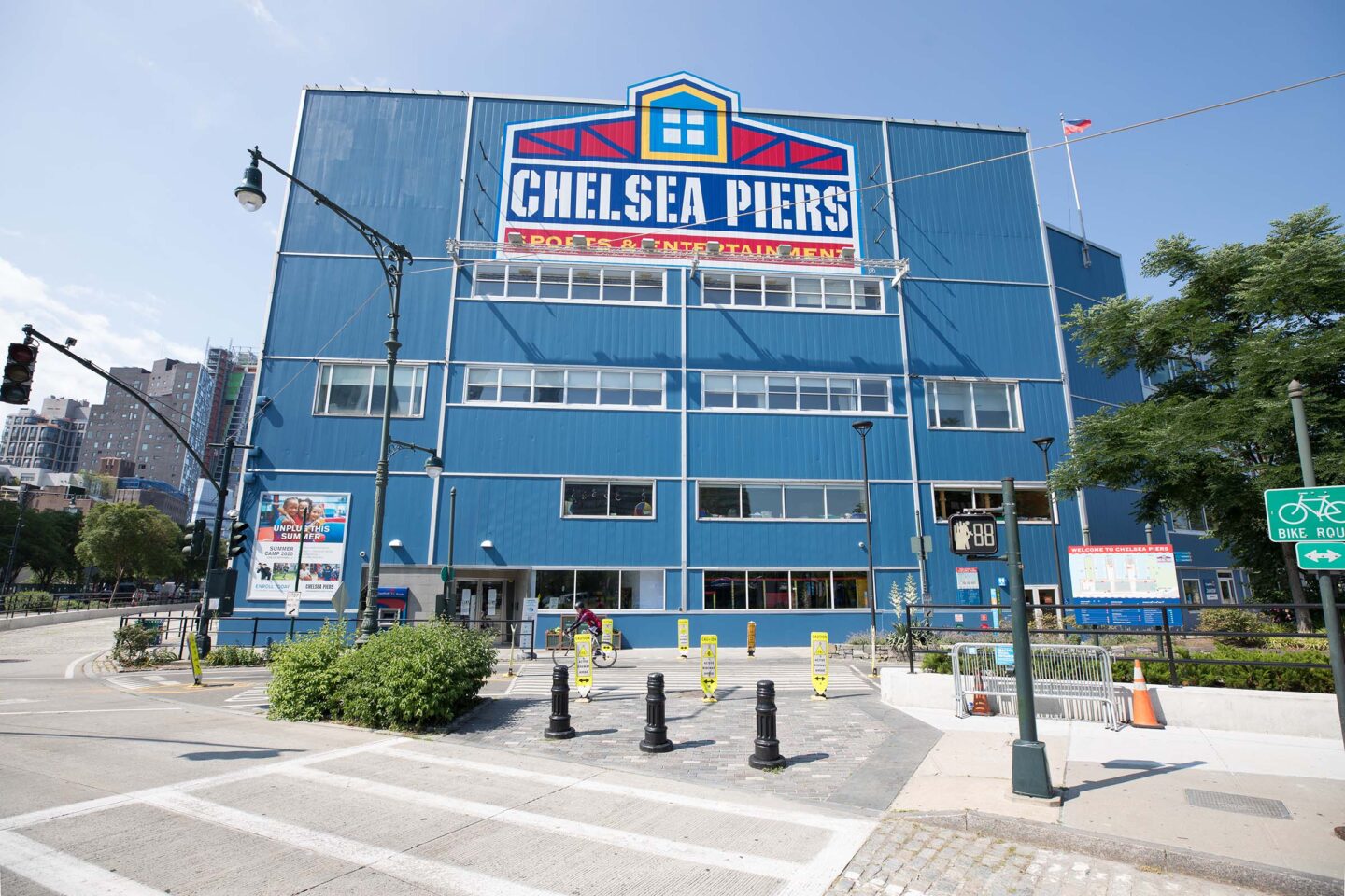 The large logo of Chelsea Piers on the blue building. The logo features a window and barn structure with Chelsea Piers written on it