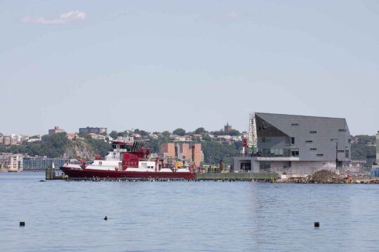 The FDNY Fire House on Gansevoort Peninsula, a red and white fireboat is docked