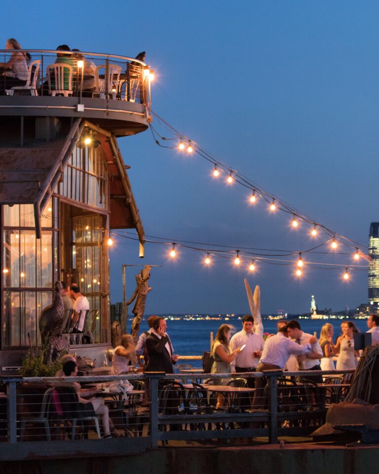 A string of bright lights illuminates the seating area on The Frying Pan in Hudson River Park