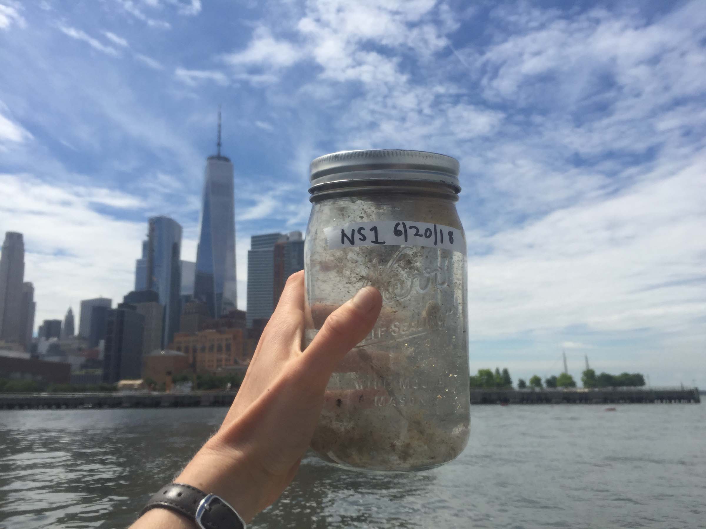 A scientist holds up a jar of a specimen
