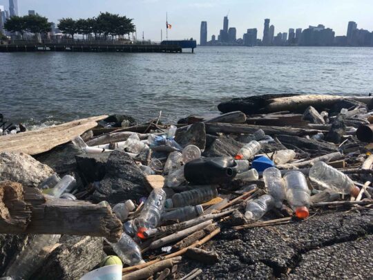 Plastic bottles and bags sit on the end of Gansevoort Peninsula