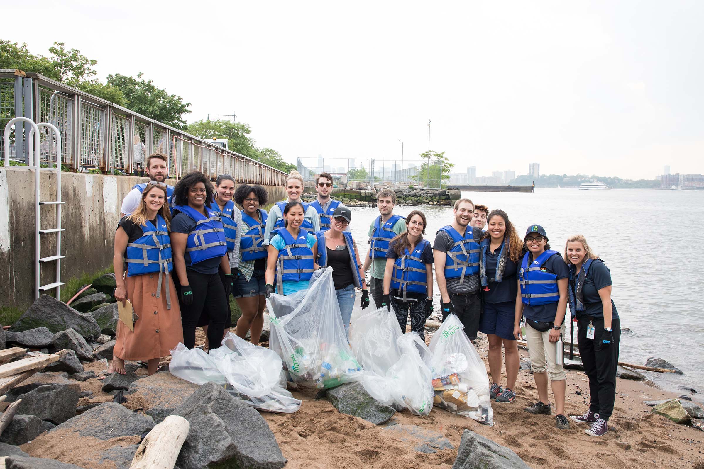 A group of volunteers help pick up plastic and litter near Gansevoort Peninsula