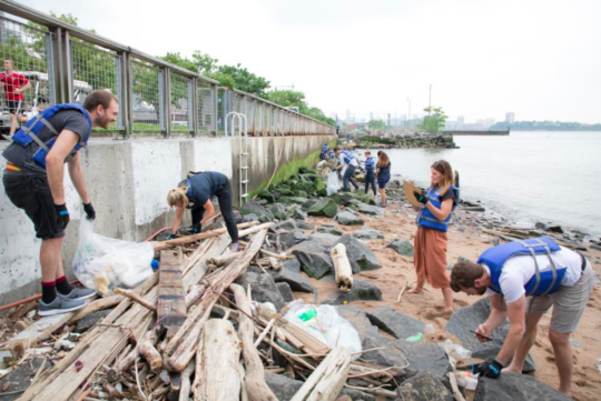 A group of volunteers clean up the plastic that was thrown on the Gansevoort Peninsula