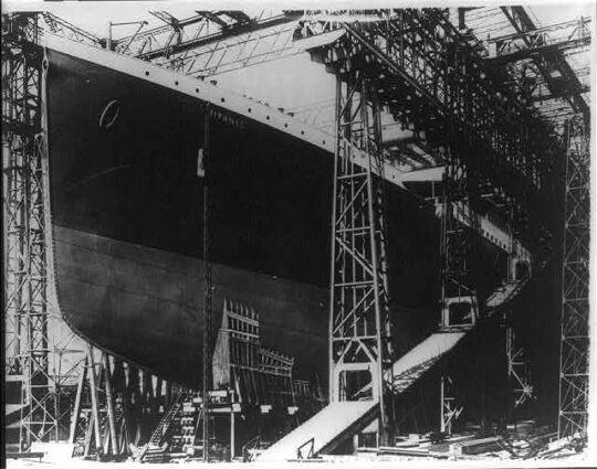 The Titanic before its voyage being prepped with cargo