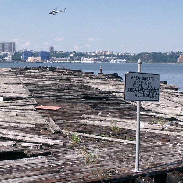 Pier 66 as a dilapidated pier crumbling in the river with a sign saying "keep off"