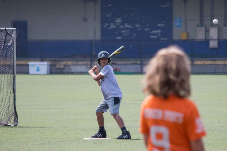 A baseball player prepares to swing the bat