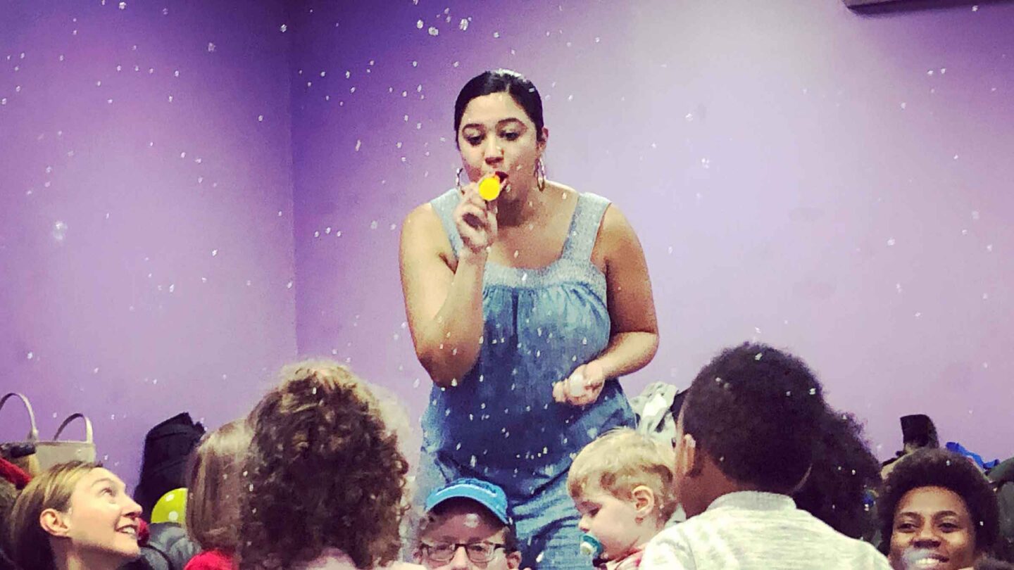 Performer at Shine on Kids plays a kazoo for the kids in the audience