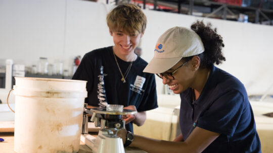 Two happy scientists smiling at what they've discovered