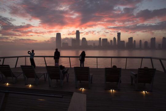 People watching the sunset from the western end of Pier 26