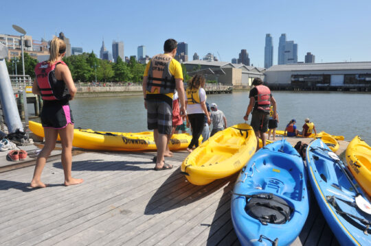 Kayakers head off into the water from the Pier 96 Boathouse at Hudson River Park