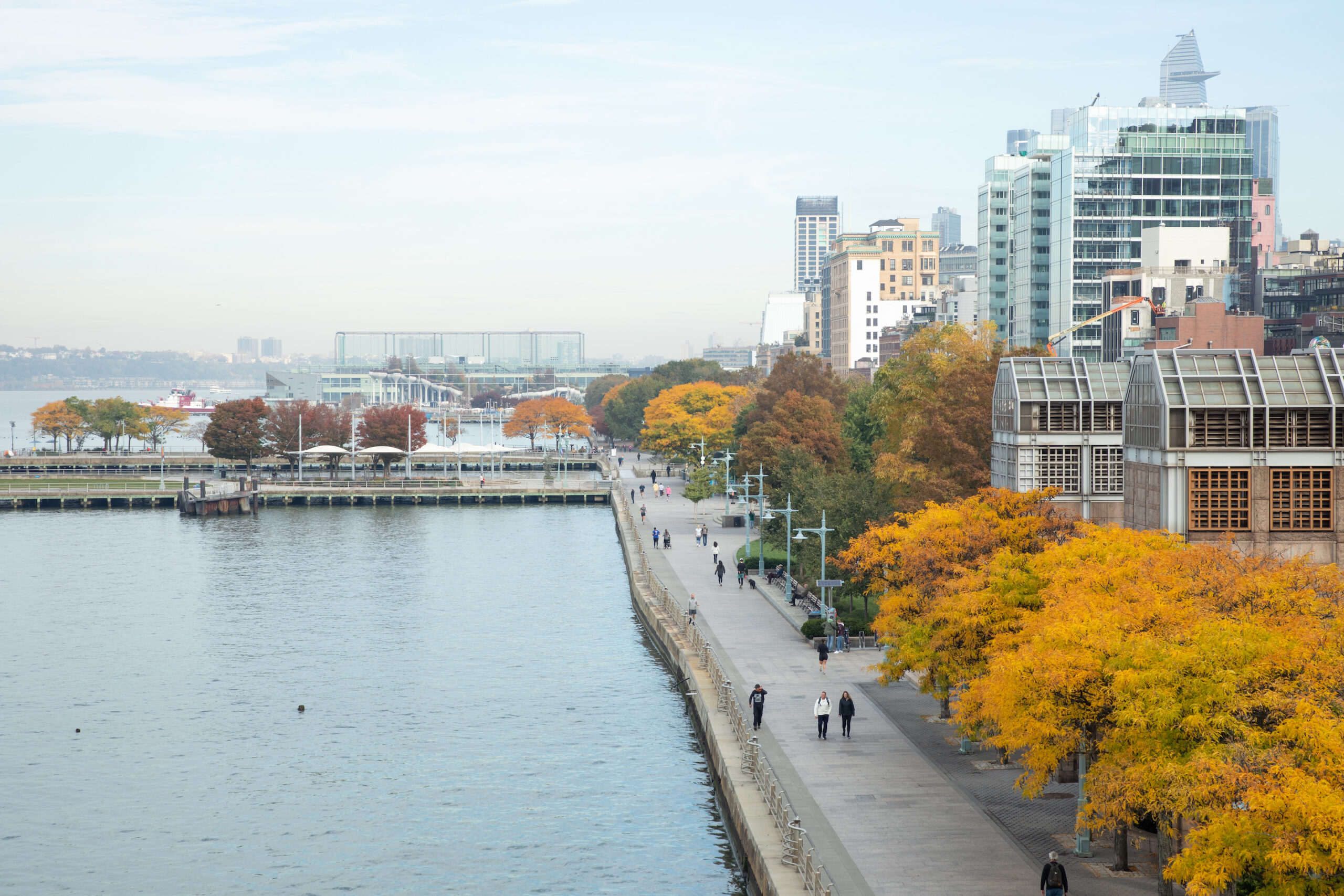 colorful autumn foliage along Hudson River Park's esplanade in NYC