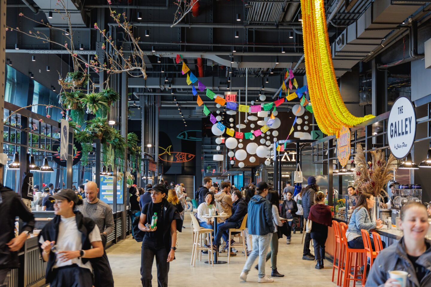 People walking and shopping at Market 57, a food hall at Pier 57