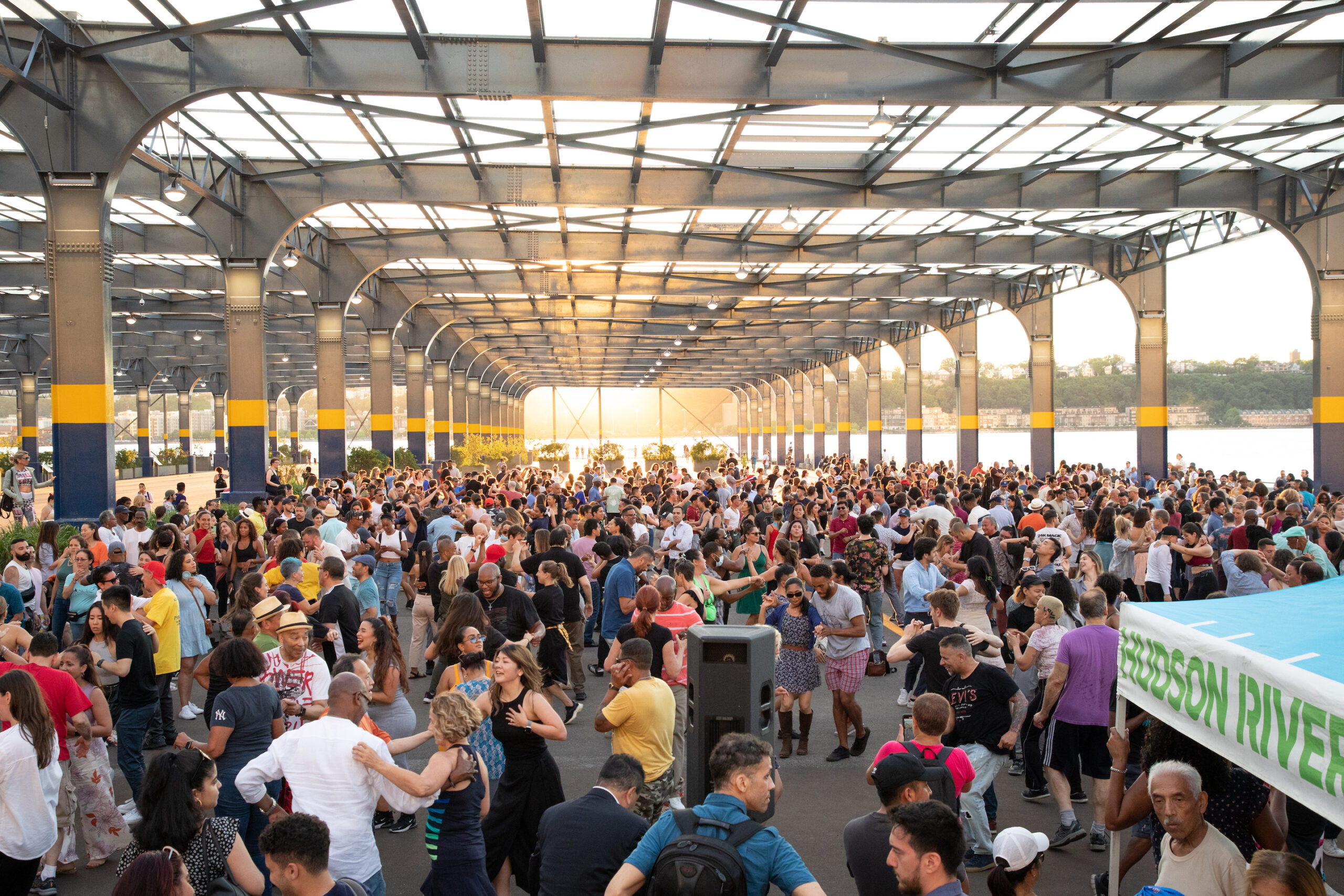 A crowd of people dancing at HRPK's Sunset Salsa on Pier 76.