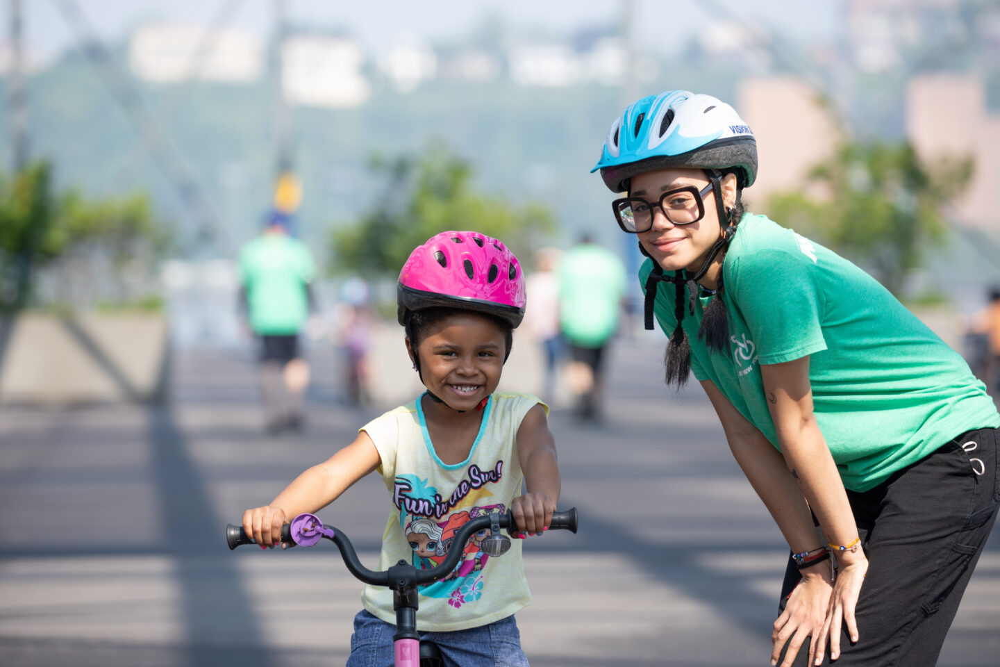 A Bike New York instructor smiling with a student at the Bike Skills 101 class for kids