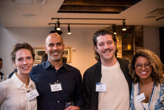 People smiling at membership event