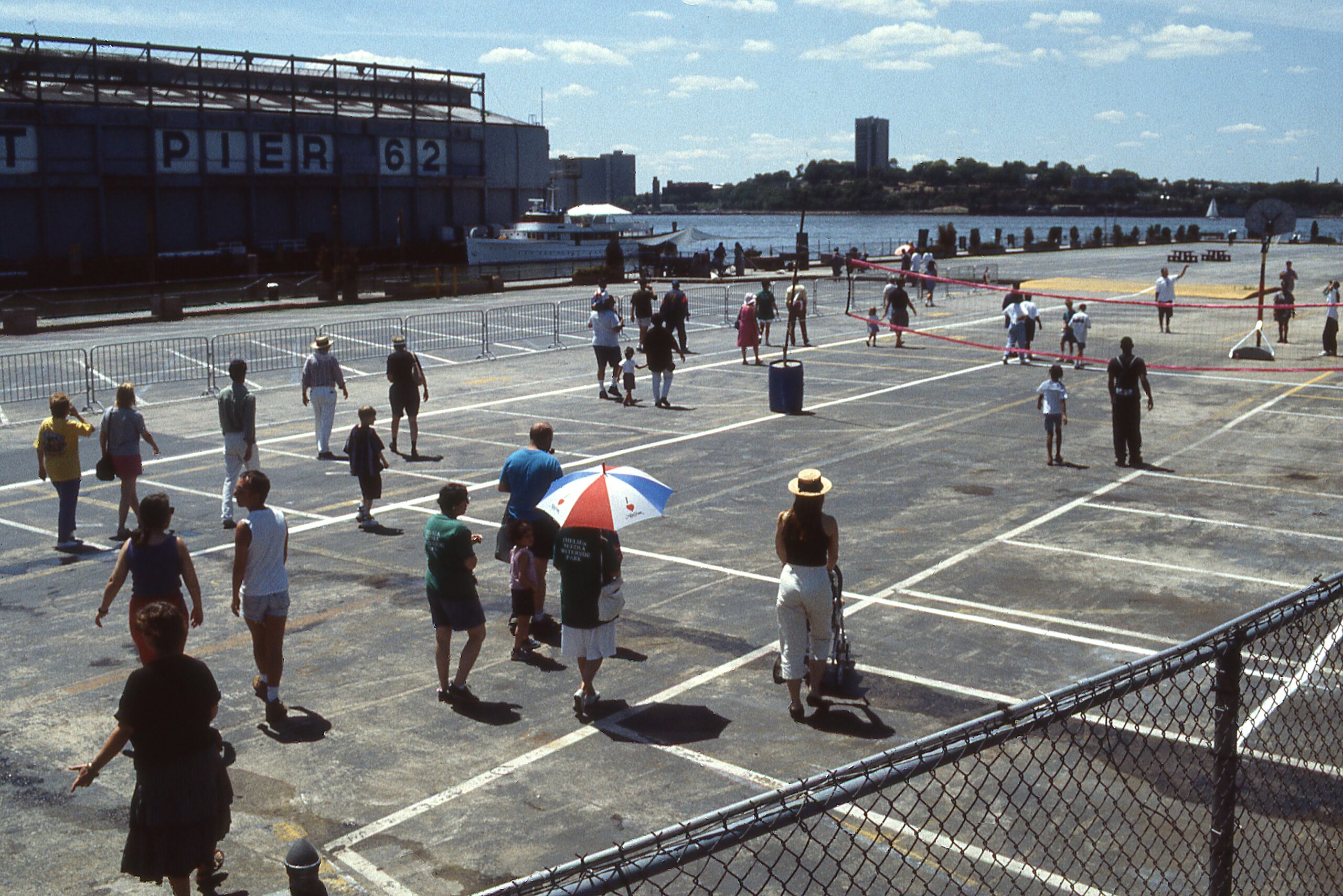 Park visitors walk over an asphalt area on Pier 63 prior to its renovation