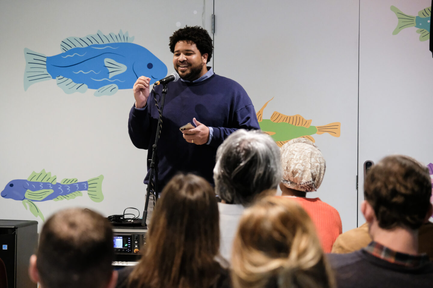 A speaker in front of an audience at a Discovery Tank event