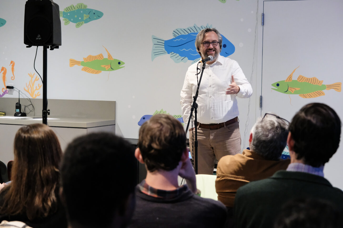 A speaker in front of an audience at a Discovery Tank event