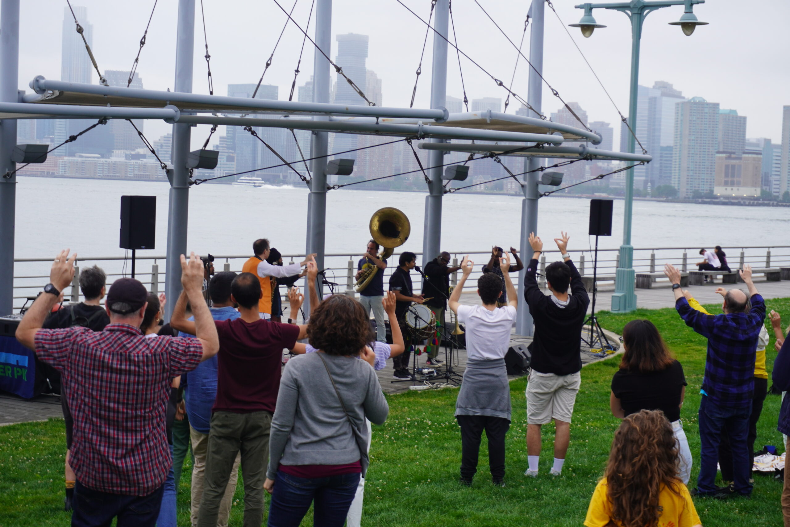 The audience dances on the Pier 45 lawn during a musical performance