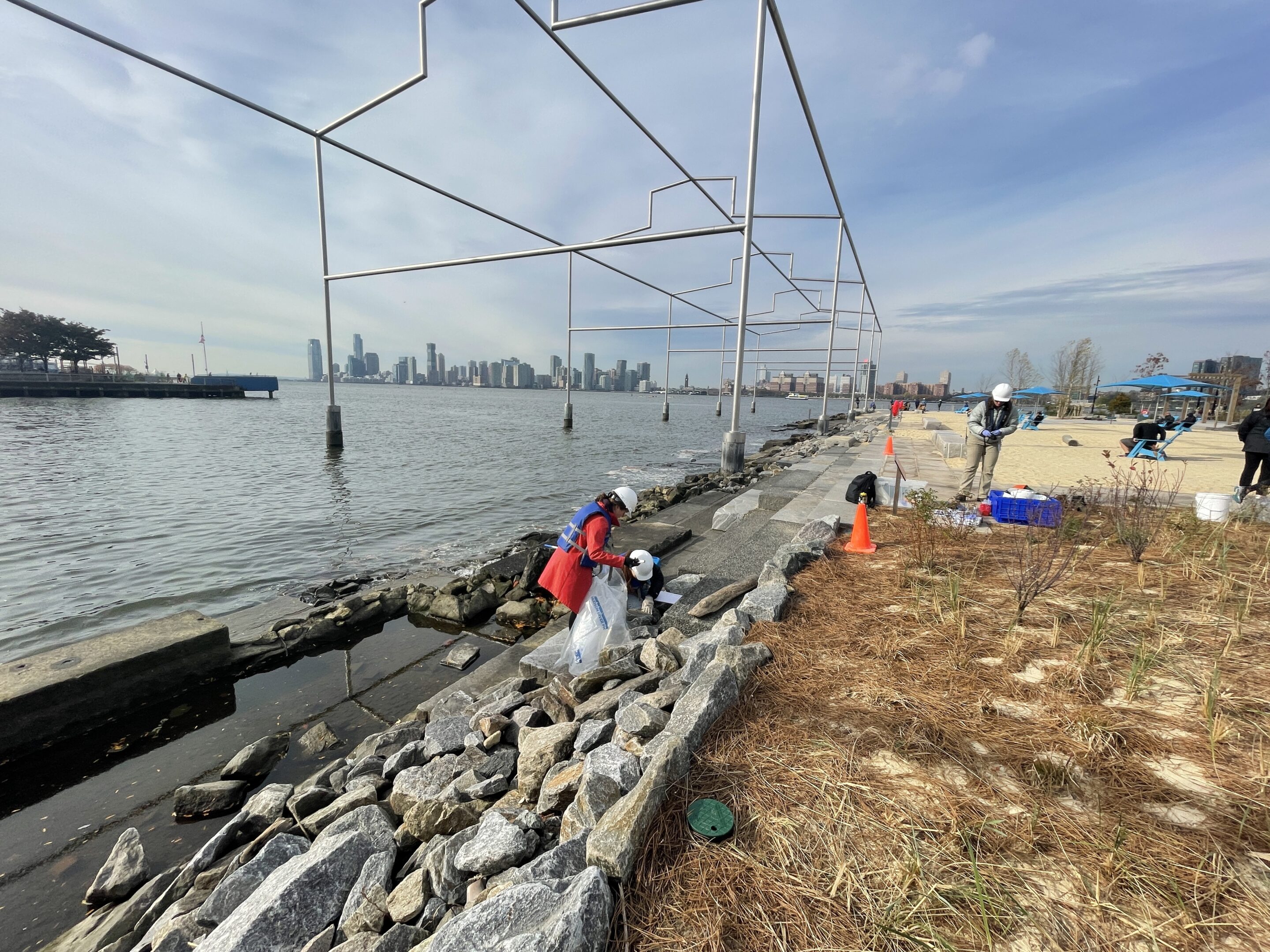 HRPK Blue Team volunteers picking up litter along the Gansevoort Peninsula shoreline