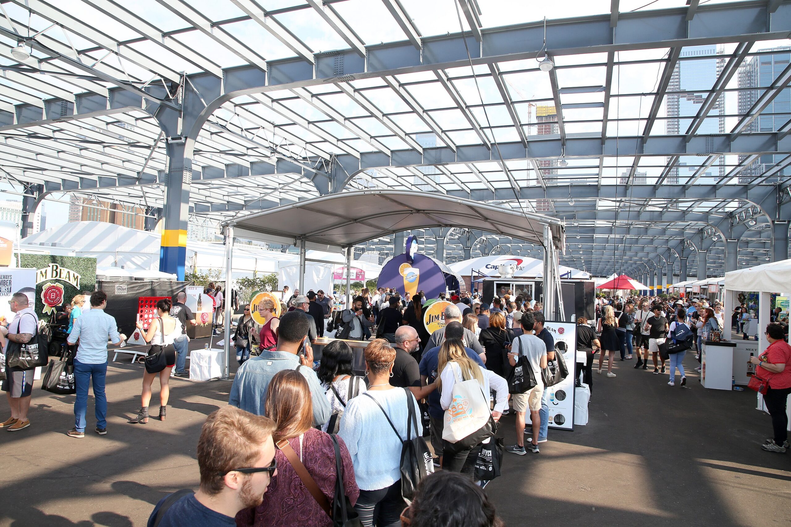 Visitors line up for food and drink vendor booths at the New York City Wine and Food Festival on Pier 76