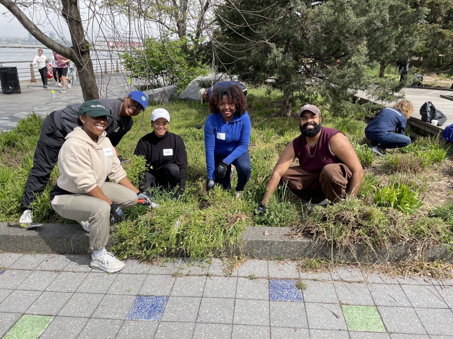 HRPK Green Team volunteers gathered for a photo in a Park garden bed