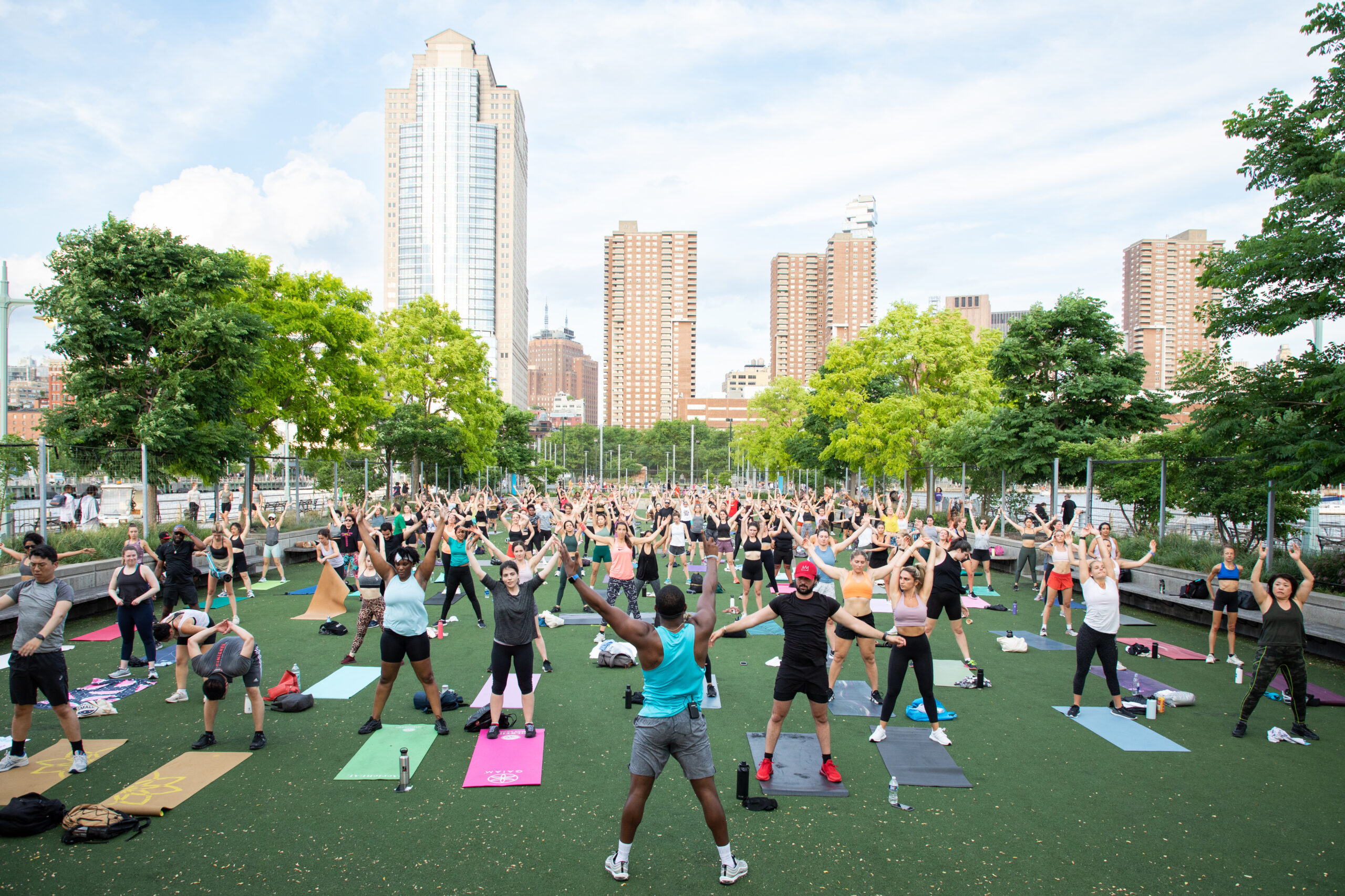 An instructor leads a Healthy on the Hudson exercise class on the Pier 25 Turf Field