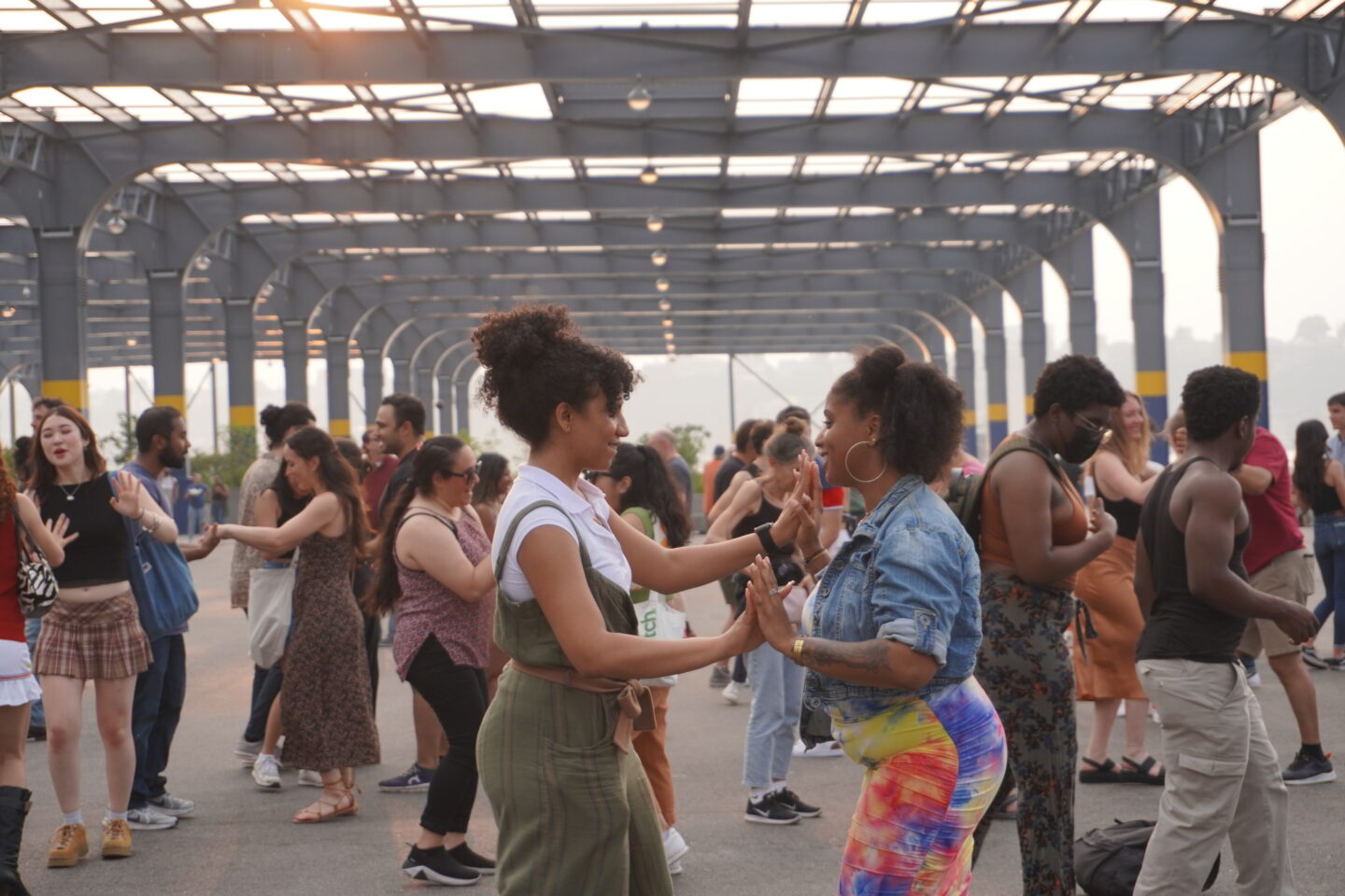 Two people dancing together during a Sunset Salsa class on Pier 76