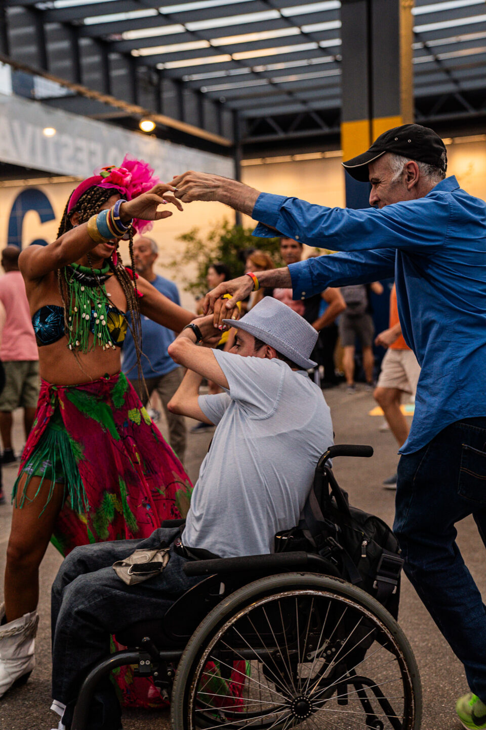 Two people dancing with a person in a wheelchair during a Dance is Life event
