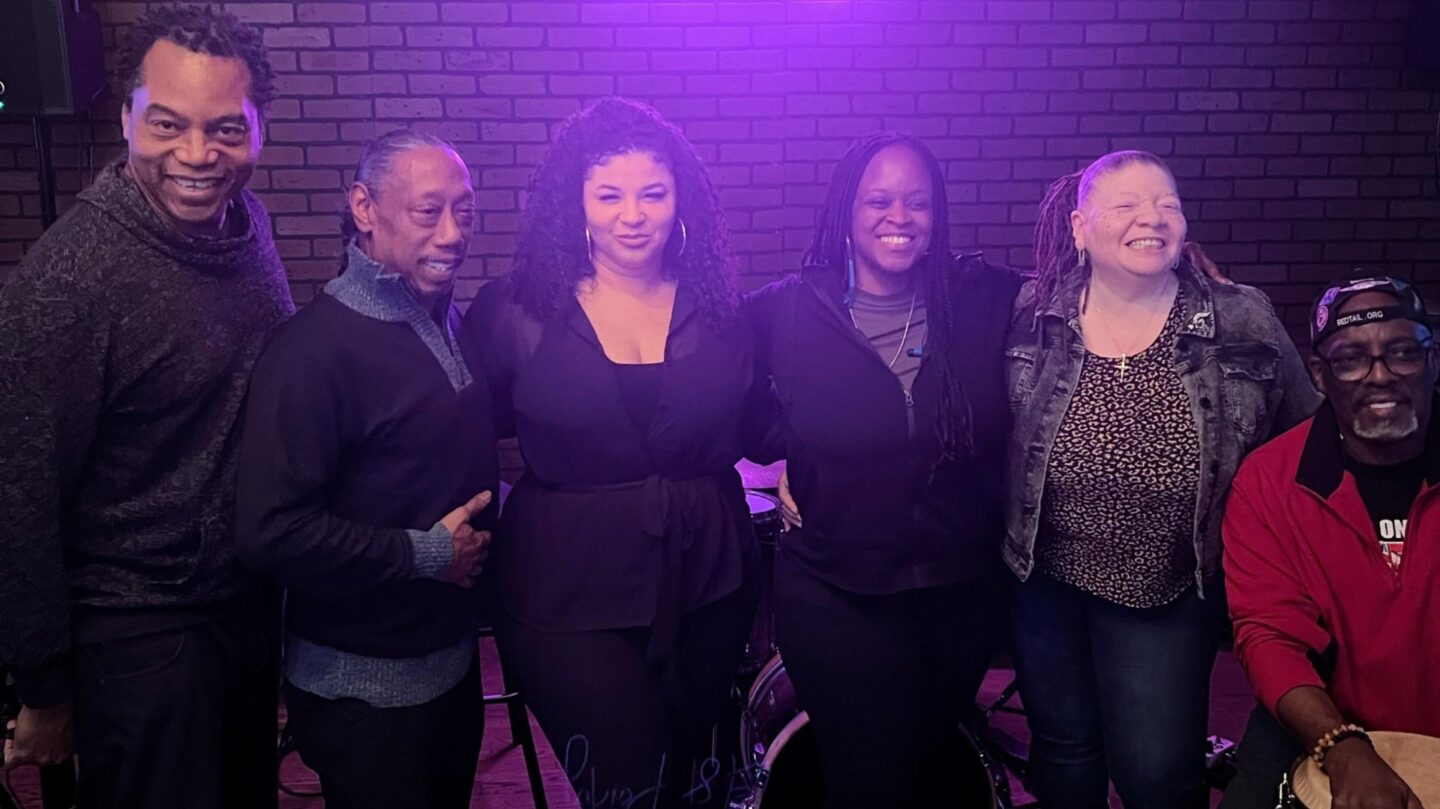 Debbie Knapper and the Knappertime Band members stand alongside one another