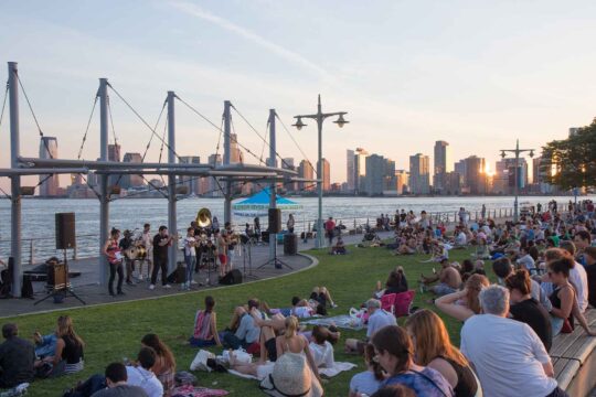 Park visitors enjoy a Sunset on the Hudson performance at Pier 45