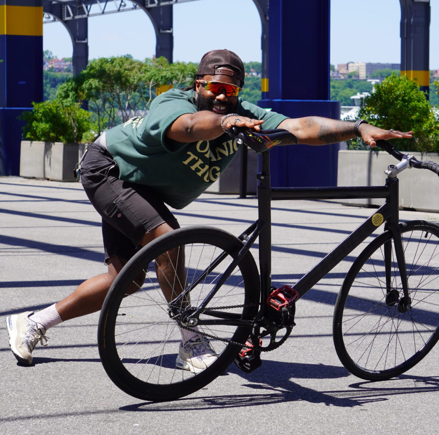 KR Jones performing a yoga pose on Pier 76, assisted by a bicycle
