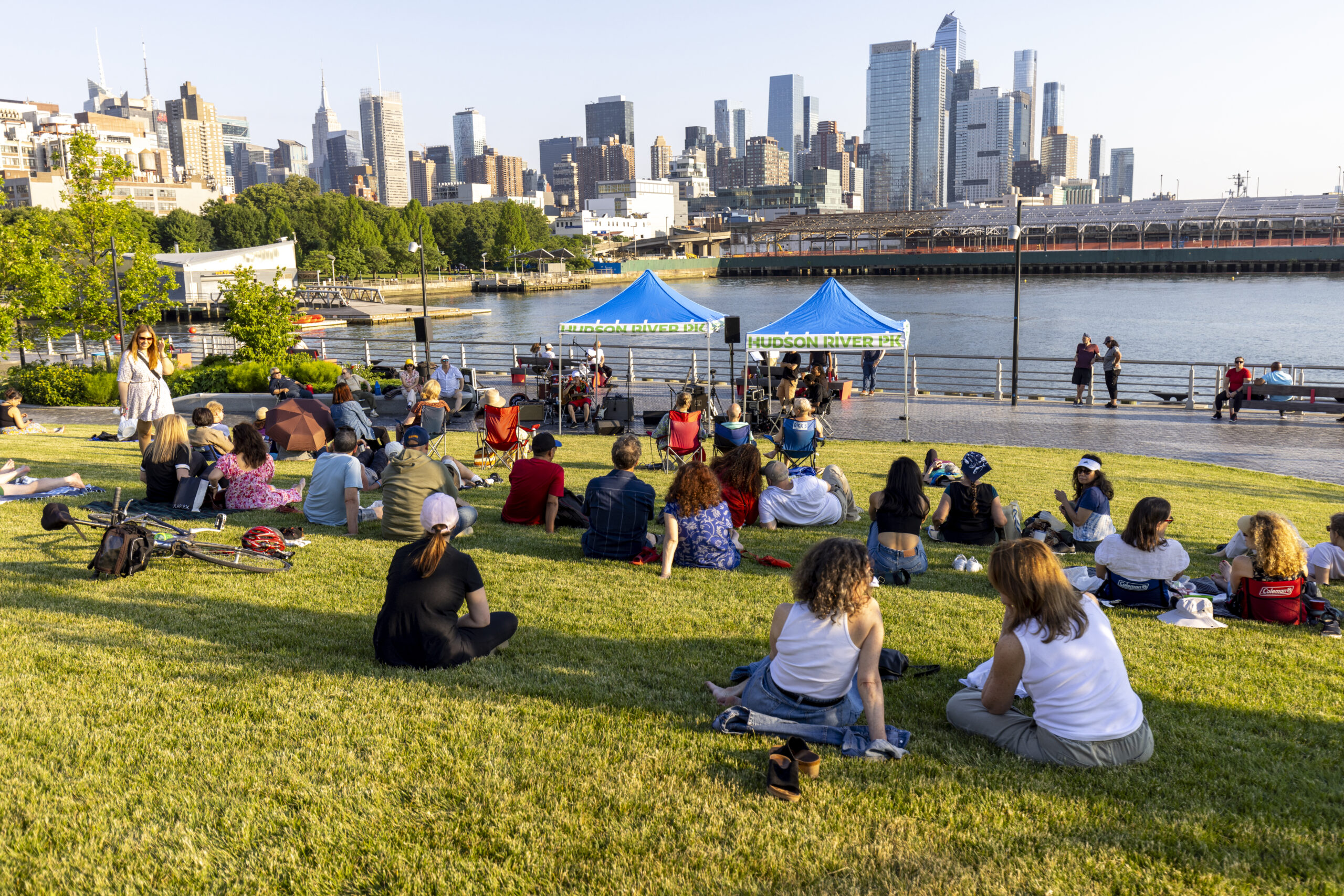 An audience sits on the Pier 97 lawn during a Blues by the Boardwalk concert