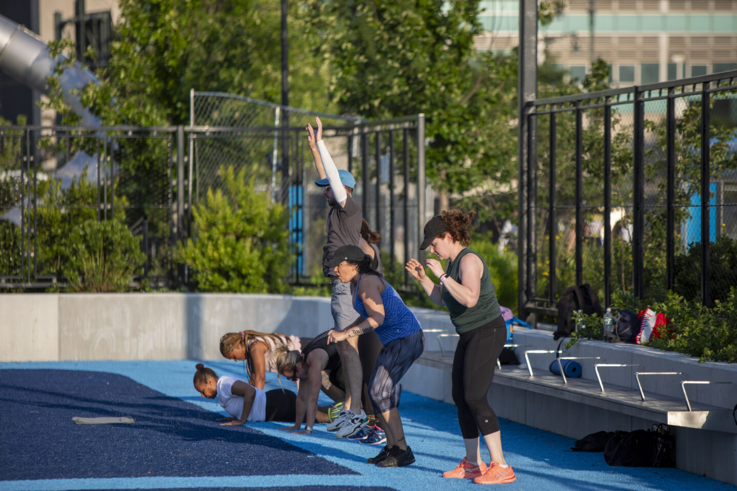 Participants in a HIIT class exercise on the Pier 97 Athletic Field
